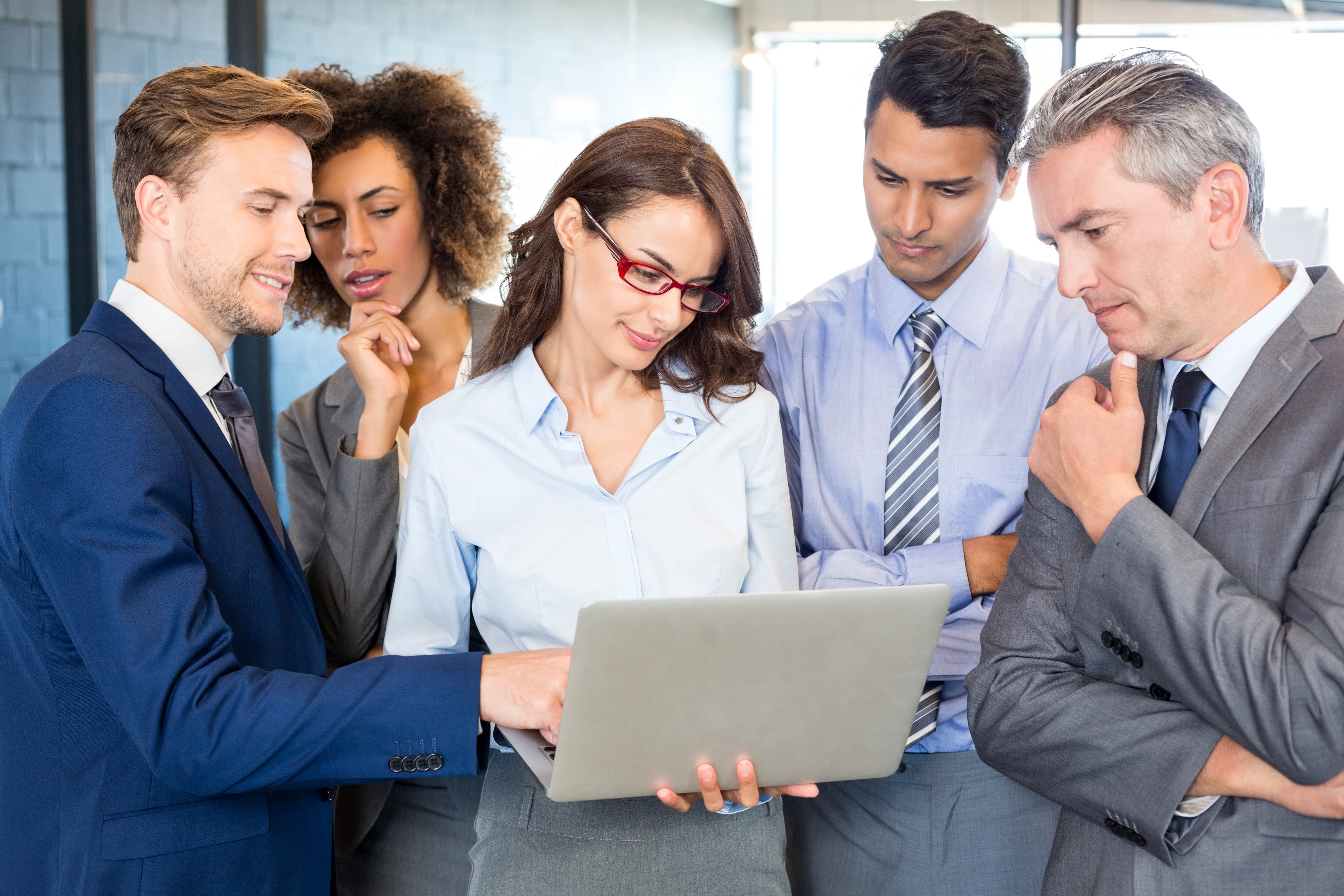 Team reviewing laptop