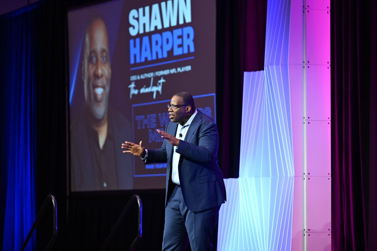 Speaker presenting on an MPI keynote stage