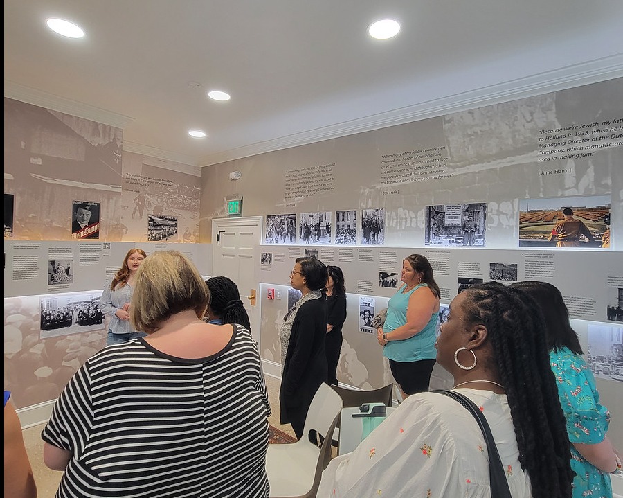 Group of people looking at museum exhibit.