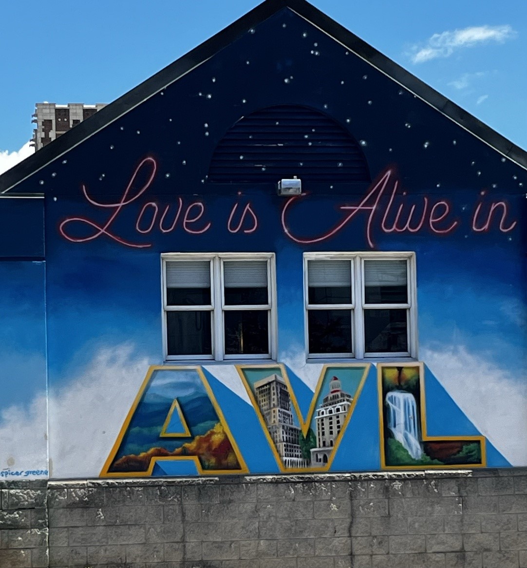 Artwork on side of a building says Art is alive in A V L.