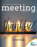 meeting cover with three candles and the word thankful over top. issue title a year in gratitude