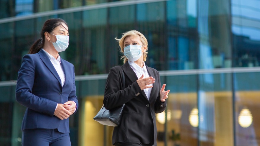businesswomen-wearing-office-suits-and-masks-picture-id1262838764